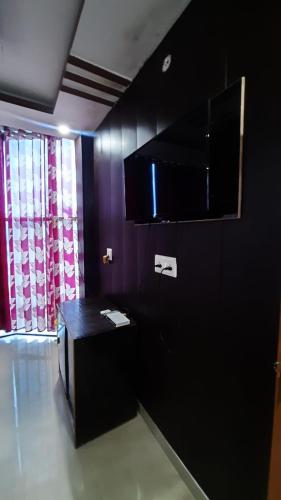 a black room with a table and a window at Hotel Rajganga in Gonda