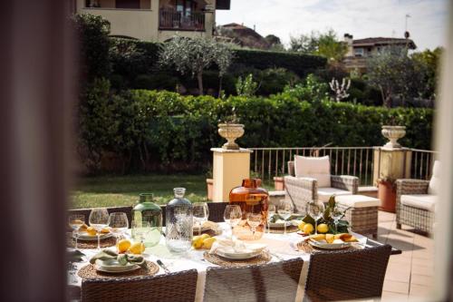 a table with glasses and wine bottles on a patio at Villa Mary in Montinelle