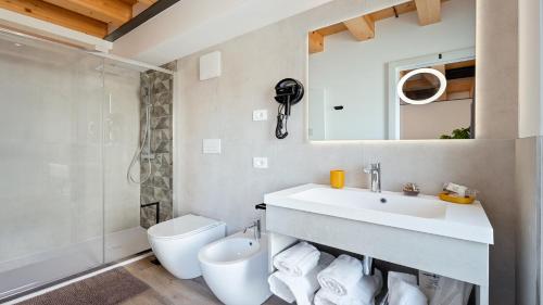a bathroom with a sink and a toilet and a shower at Luxea Guest House - B&B Treviso in Preganziol
