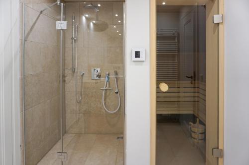 a bathroom with a shower with a glass door at Lachmöwe in List