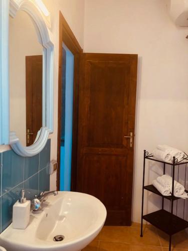 a bathroom with a white sink and a mirror at Dépendance Liscio in Filicudi