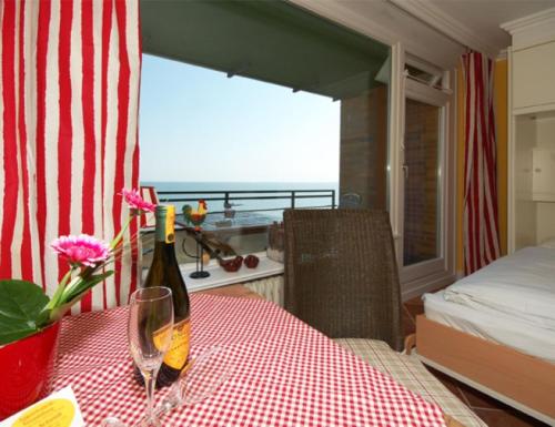 a table with a bottle of wine and a glass at Wattenblick 51-35 in List