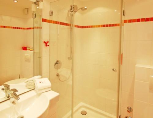 a bathroom with a shower and a sink at Wattenblick 51-35 in List