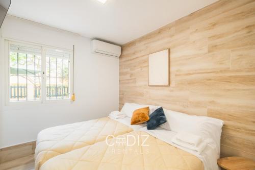 a bedroom with white walls and a large bed at Hospederia IMAR by Cadiz4Rentals in Cádiz