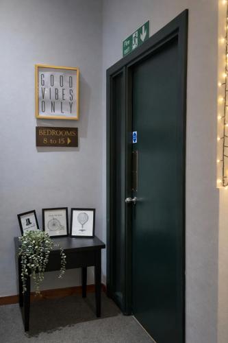 a green door in a room with a table at Boreland Lodge Hotel in Inverkeithing