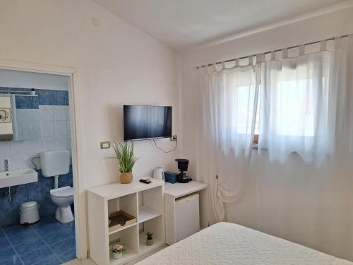 a white bathroom with a toilet and a sink at Apartments and Rooms Lorena 236 in Rovinj