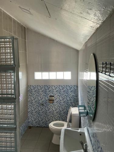 a bathroom with a toilet and a sink and a mirror at elephant garden in Ban Bang Bao