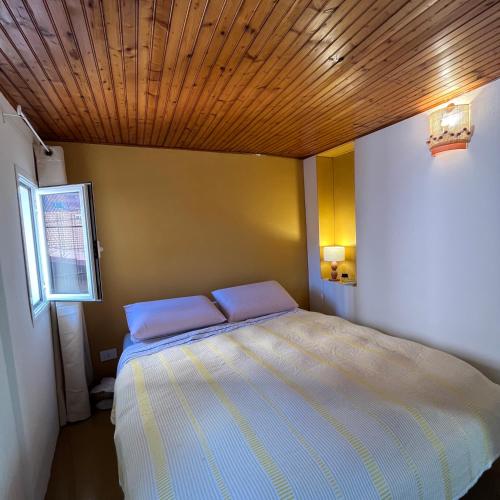 a bedroom with a bed with two pillows on it at Cavour 66 Apartment in Ventimiglia