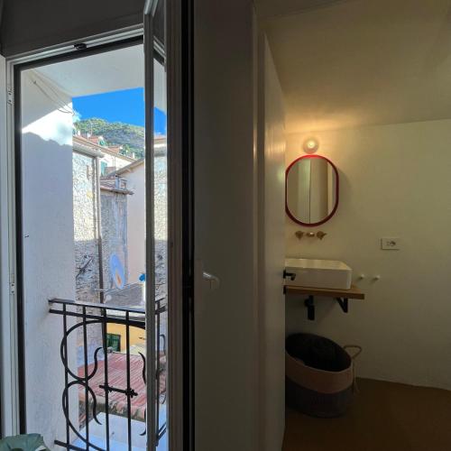 a bathroom with a sink and a mirror on the wall at Cavour 66 Apartment in Ventimiglia