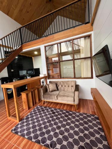 a living room with a couch and a table at Asokabin House in Diyeng