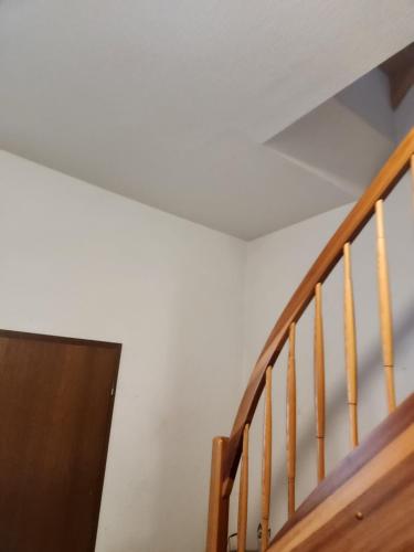 a wooden stairway with a white ceiling at Gröningen in Gröningen
