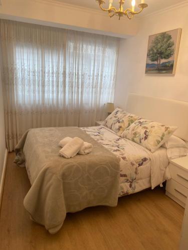 a bedroom with a bed and a window at Casa centro histórico de Viveiro in Viveiro