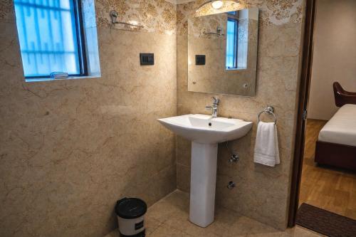 a bathroom with a sink and a mirror at RH Guest House Leh in Leh