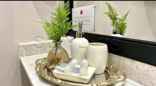 a tray with candles and a vase on a counter at Harmonia Flat's - Aeroporto Gru in Guarulhos
