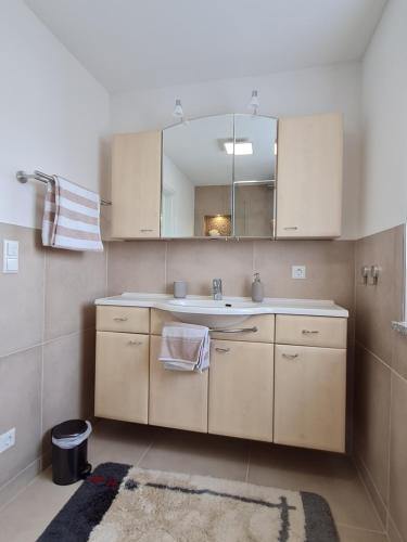 a bathroom with a sink and a mirror at Ferienwohnung Regel in Lauingen