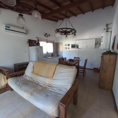 a living room with a couch and a kitchen at Cabañas del Gordo in Mar del Plata