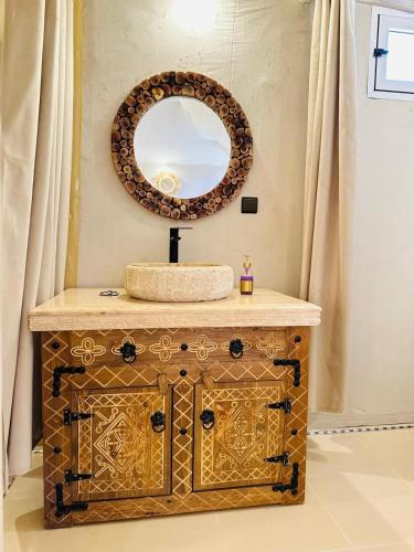 a bathroom with a sink and a mirror at Rosara Luxury Camp in Merzouga