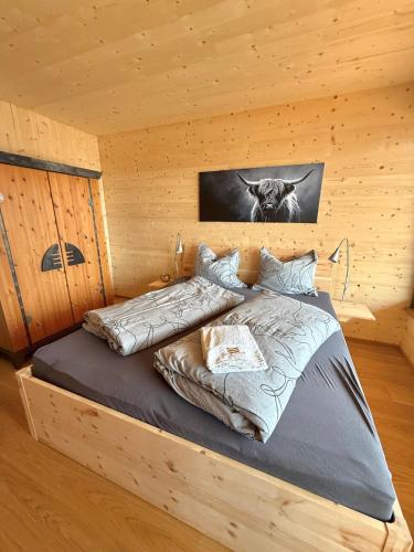 a bedroom with a bed in a wooden cabin at Wohnen am Südhang in Amberg