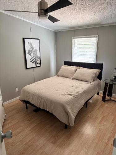 a bed in a bedroom with a ceiling fan at 3 bedroom River cabin retreat ! in Terre Haute
