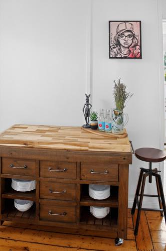a wooden dresser in a room with a stool at Cedar Cottage Daylesford in Daylesford