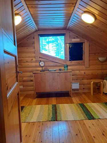 a room with a desk in a wooden cabin at Villa Kalkonniemi in Kemijärvi