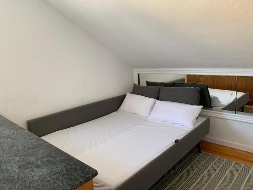 a small room with a bed with white pillows at Apartamento somo SARR in Somo