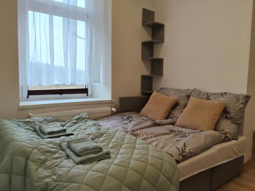 a bed with towels on it in a room with a window at Pod Dzikowcem in Boguszów-Gorce