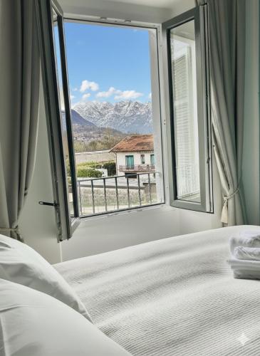 a bedroom with a bed and a window with a view at Villa Felix in Omegna
