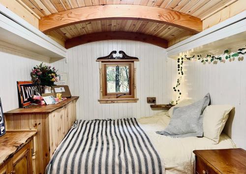 a bedroom with a bed and a wooden ceiling at Mòr Braw in Banavie
