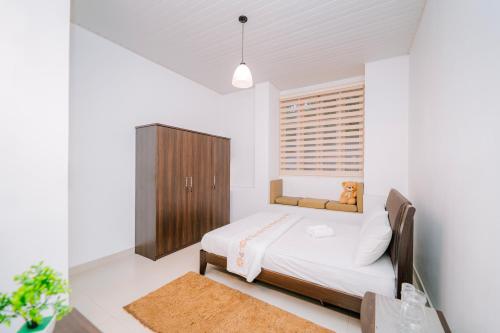 a bedroom with a bed and a wooden cabinet at Heaven R in Kandy