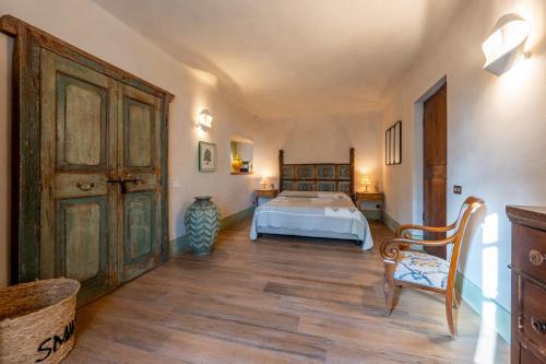 a bedroom with a bed and a wooden floor at Villa Rosmarino in Imperia