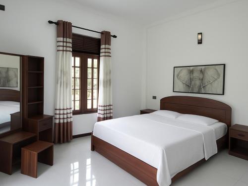 a bedroom with a large bed and a mirror at Nimsara Homes in Veyangoda