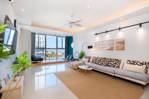 a living room with a couch and a table at Kozy Home Apartment in Vung Tau - Tam Thang Tower View & Back Beach step away in Vung Tau