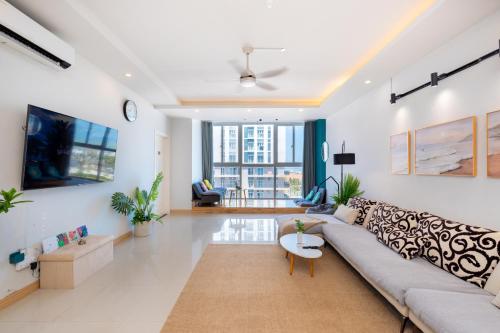 a living room with a couch and a table at Kozy Home Apartment in Vung Tau - Tam Thang Tower View & Back Beach step away in Vung Tau