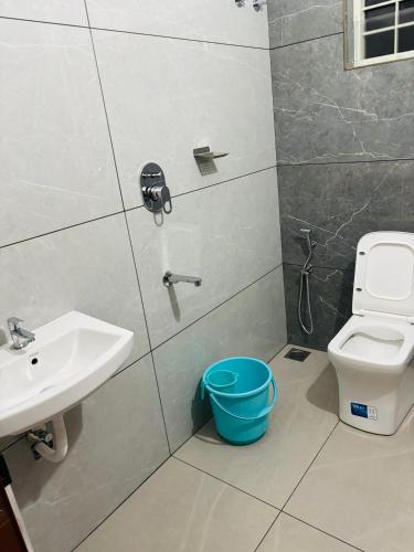 a bathroom with a sink and a toilet at Mansori Residency in Cochin