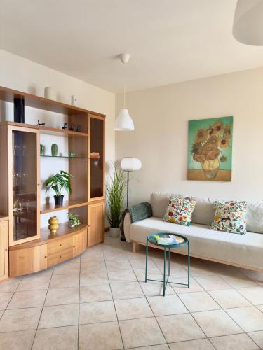 a living room with a couch and a table at Casa Diana - Panoramablick auf den Gardasee in Pieve