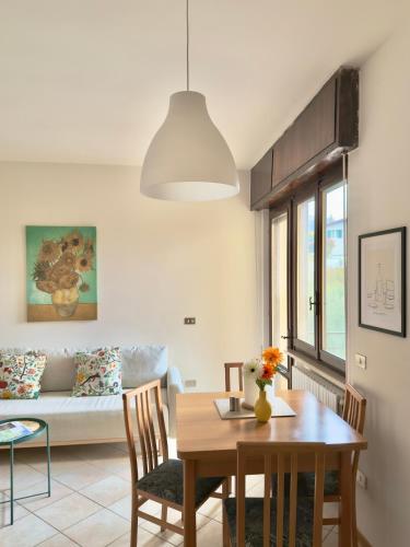a living room with a table and a couch at Casa Diana - Panoramablick auf den Gardasee in Pieve