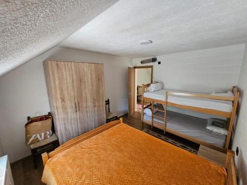 a bedroom with two bunk beds in a room at Villa Fresku in Peje