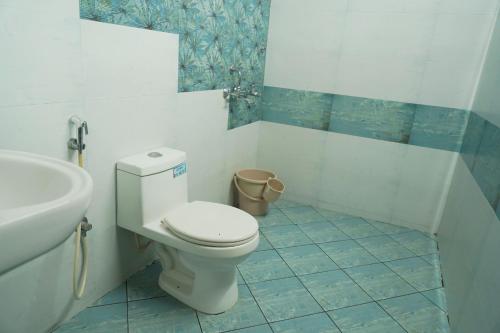 a bathroom with a toilet and a sink at Orange valley Town Residency in Trivandrum
