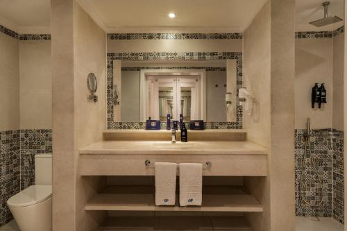 a bathroom with a sink and a mirror at Grand Palace - Couples only 18 years plus in Hurghada