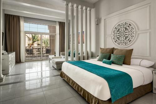 a bedroom with a large bed and a living room at Grand Palace - Couples only 18 years plus in Hurghada
