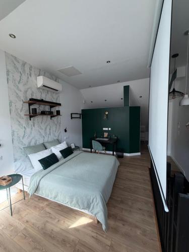 a bedroom with a large bed and a stone wall at Sylina Spa avec Jacuzzi Privé in Villeblevin