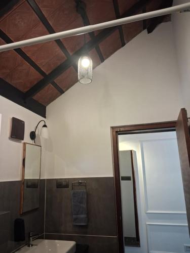 a bathroom with a sink and a mirror at Vidman Homey Huts in Tindummal
