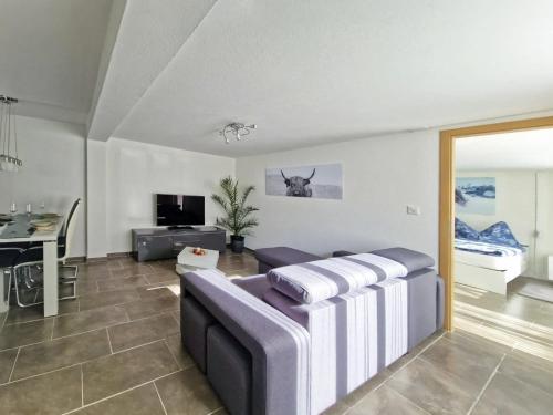 a living room with a couch and a table at Chalet Bellevue Beautiful Waterfall view private Garden & free parking in Lauterbrunnen