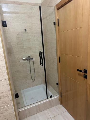 a shower with a glass door in a bathroom at harhoura Résidence Badia in Temara
