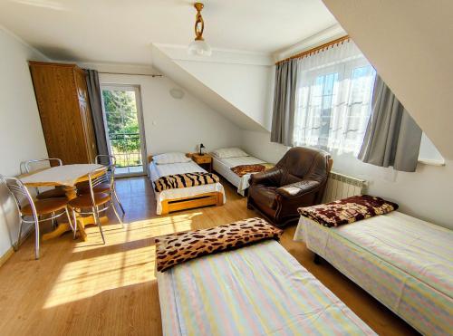a living room with two beds and a table at Agrokrysia in Krosʼtsenko