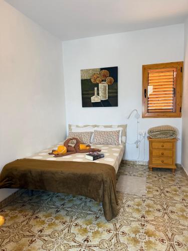 a bedroom with a bed and a table and a window at Nature in Tejeda in Tejeda