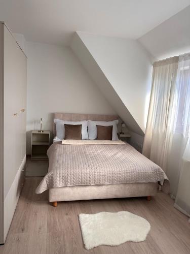 a bedroom with a large bed and a attic at Apartment Kala in Varaždin
