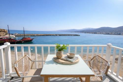 a table and chairs on a balcony overlooking the ocean at Opal Apartments Luxury by the Sea in Hersonissos