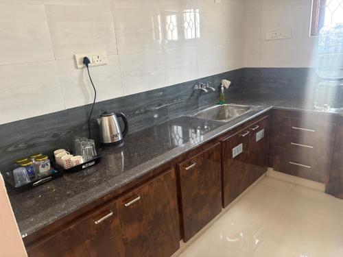 a kitchen with a sink and a counter top at Rainbow721 in Pondicherry